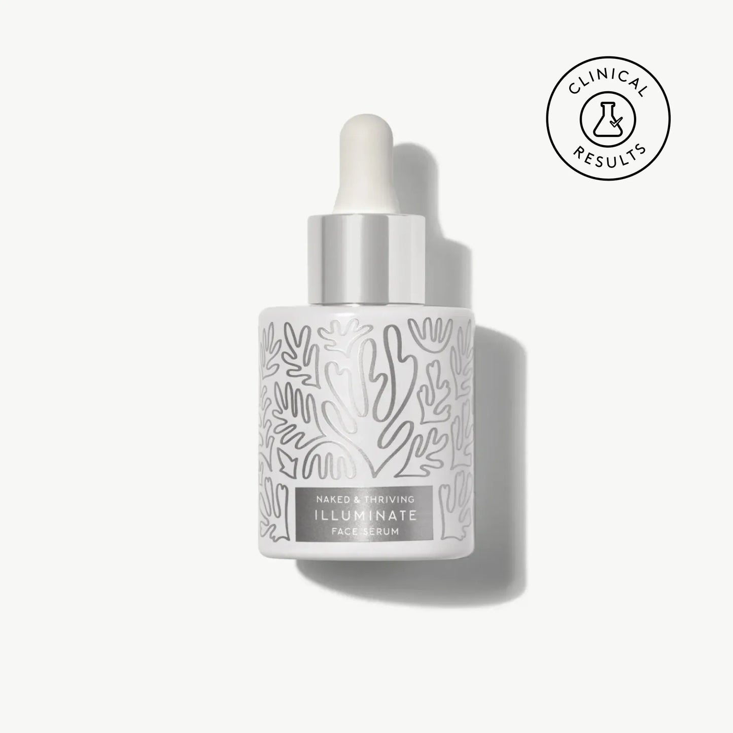 Naked & Thriving Illuminate BC+ Brightening Serum in white glass dropper bottle with light botanical pattern