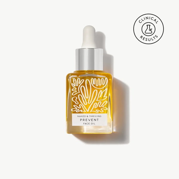 Naked & Thriving Prevent Anti-Aging Face Oil in a clear, botanical-patterned glass dropper bottle