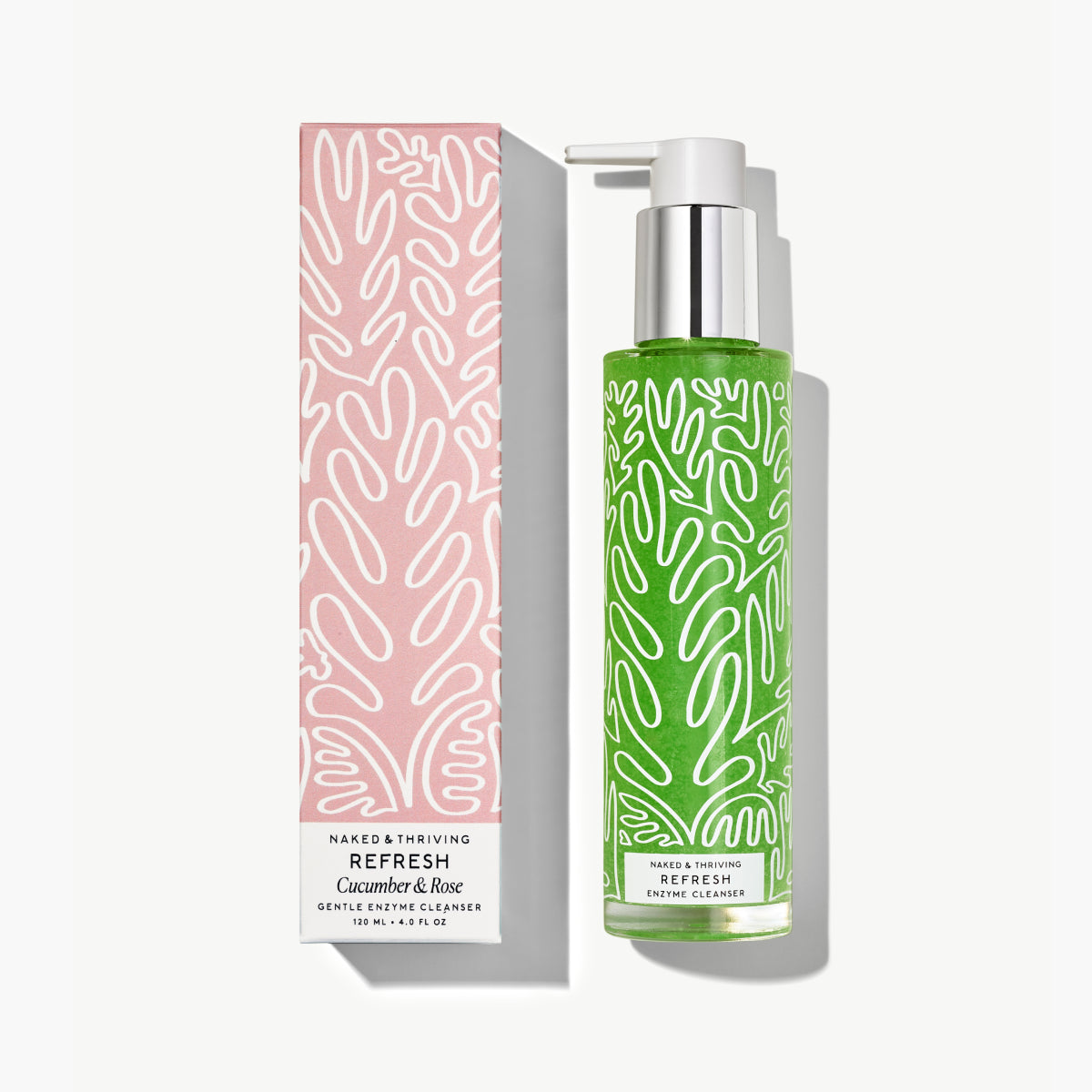 Naked & Thriving Refresh Gentle Enzyme Cleanser showing green formula inside a clear pump bottle beside a pink, botanical-patterned box