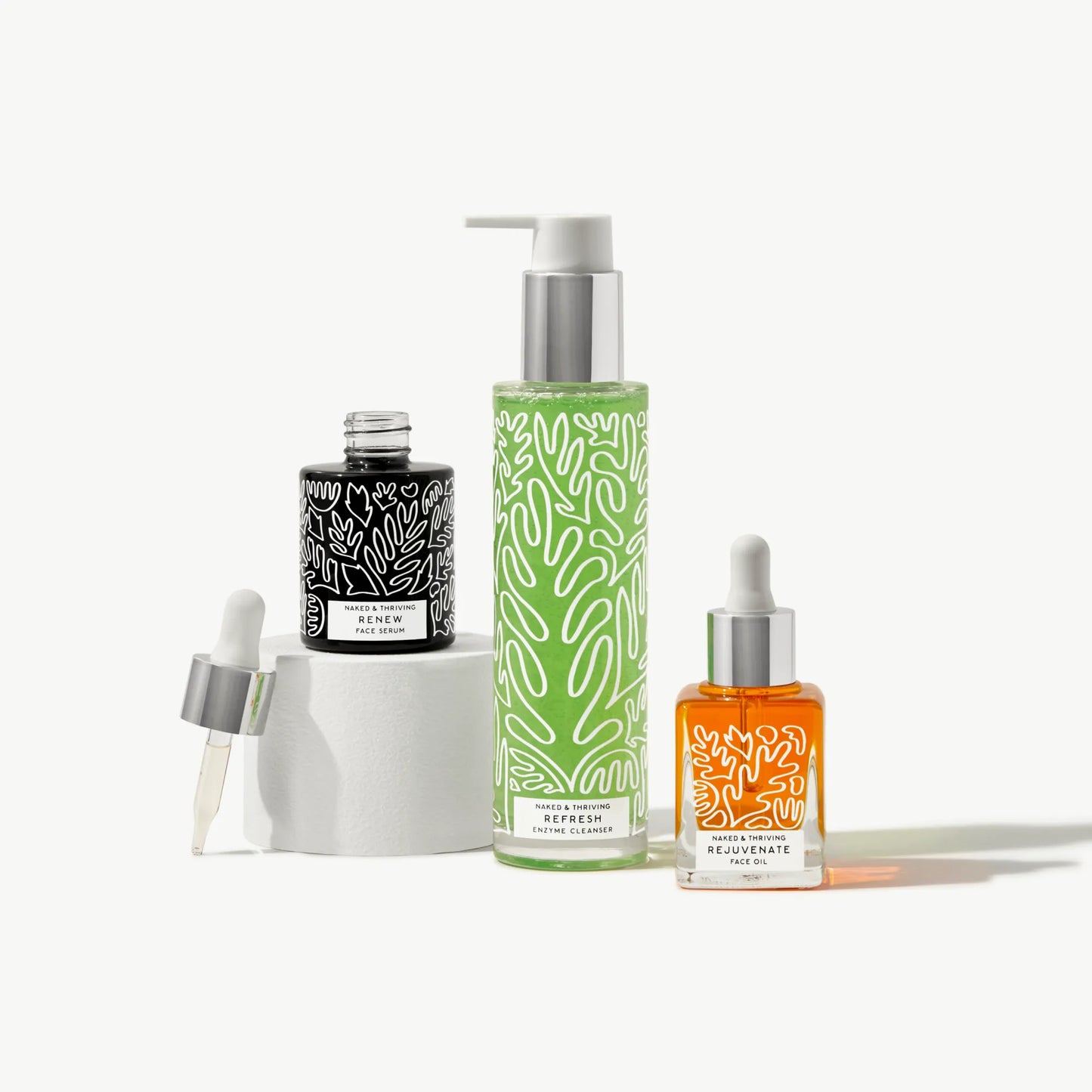 Naked & Thriving The Refresh Routine with botanical-patterned glass bottles, including pump and dropper packaging