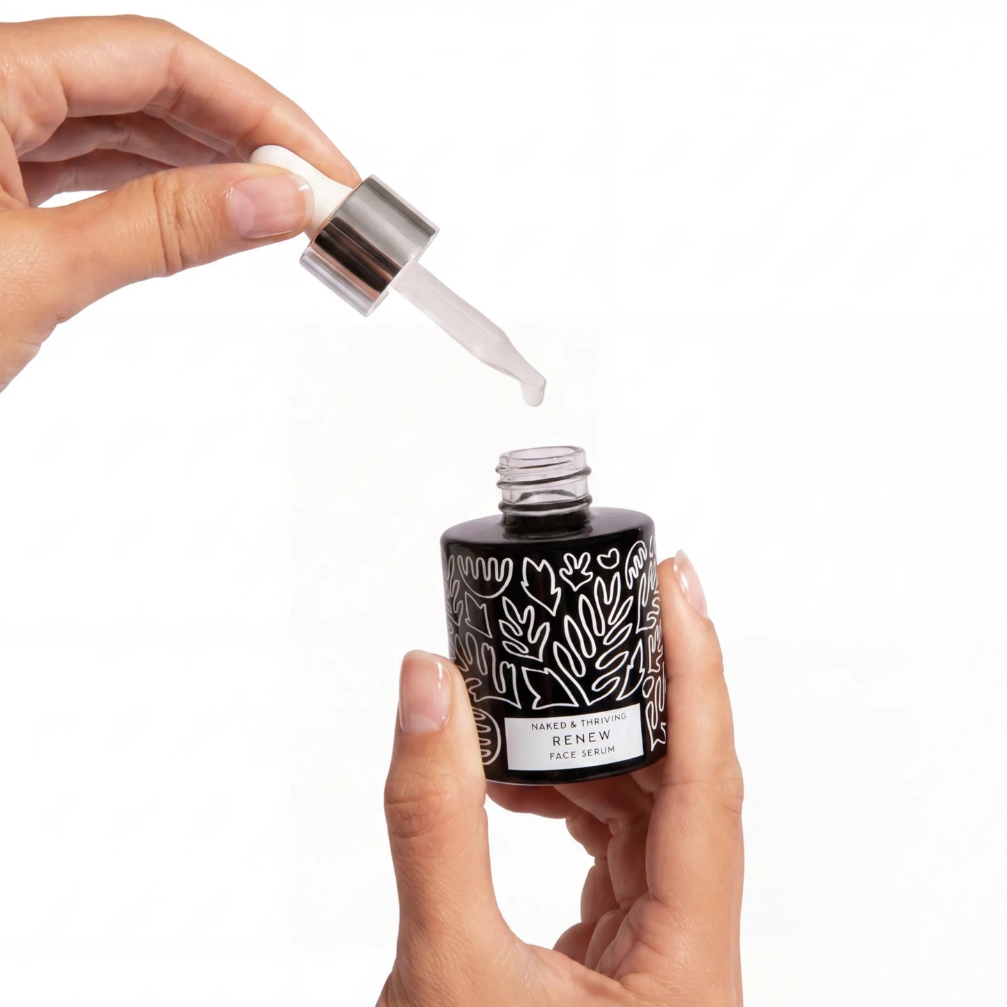 
                
                  Hand dispensing a drop of Renew Resurfacing Night Serum from its glass dropper above the open bottle
                
              