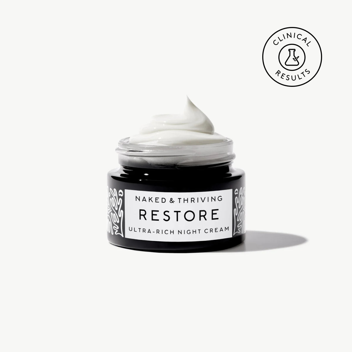 Naked & Thriving travel-size Restore Ultra-Rich Night Cream in a black glass jar with brand label on a neutral background